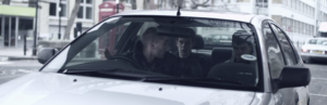 Three bank robbers in a car in the short film The Heist
